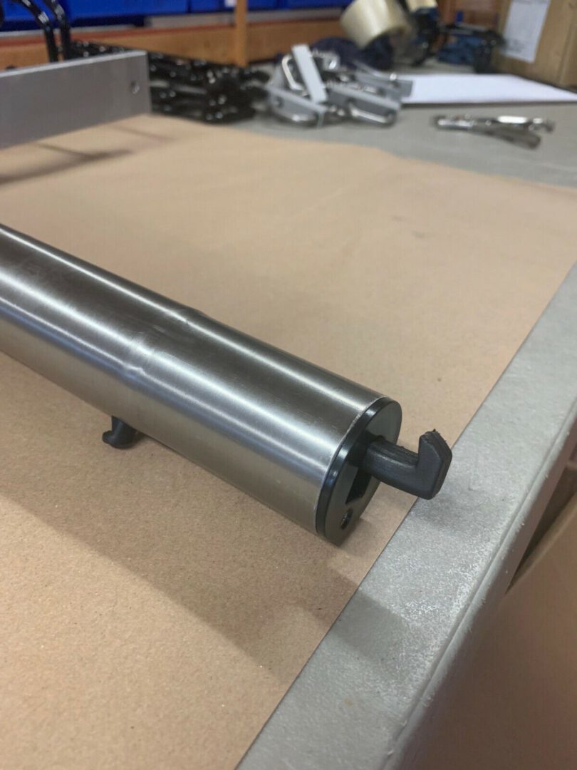 A metal roller on top of a table.