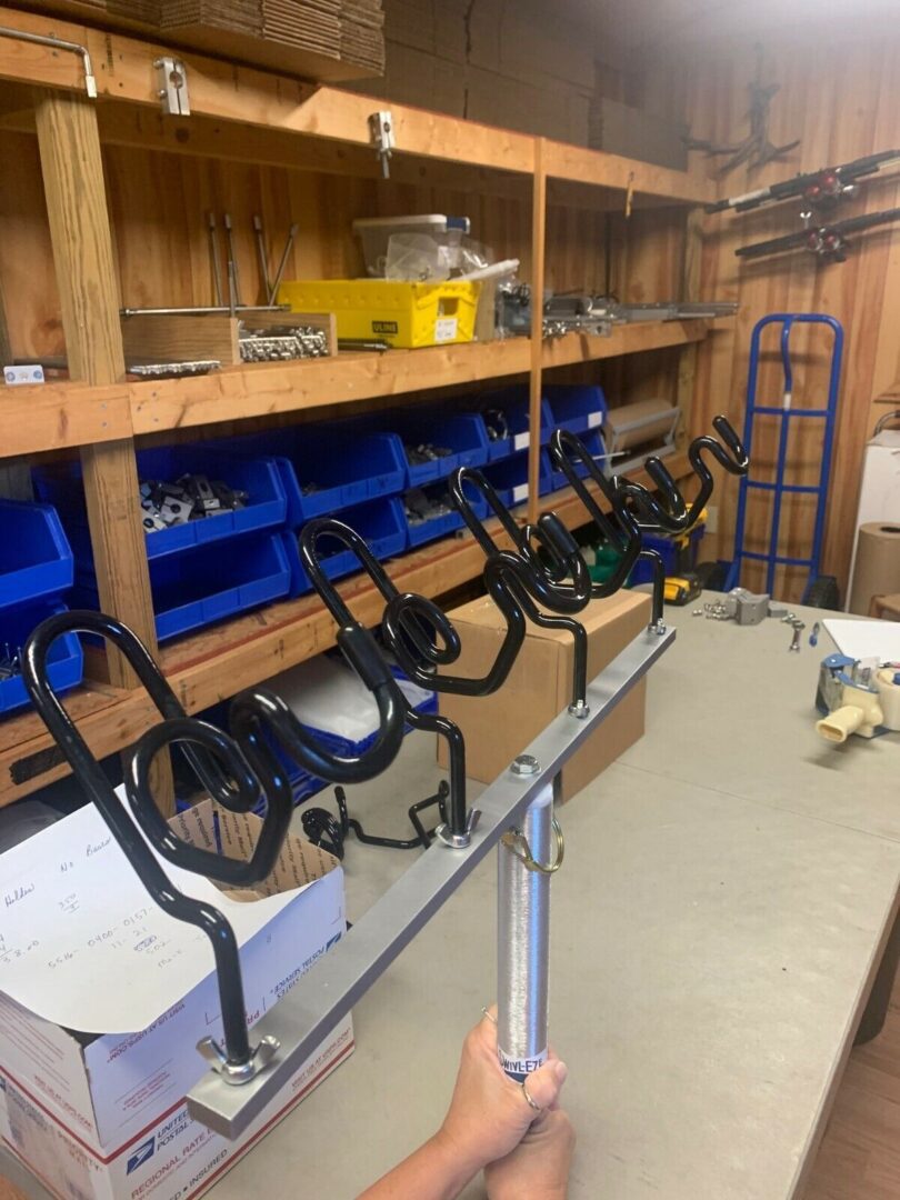 A room with many shelves and some tools hanging on it