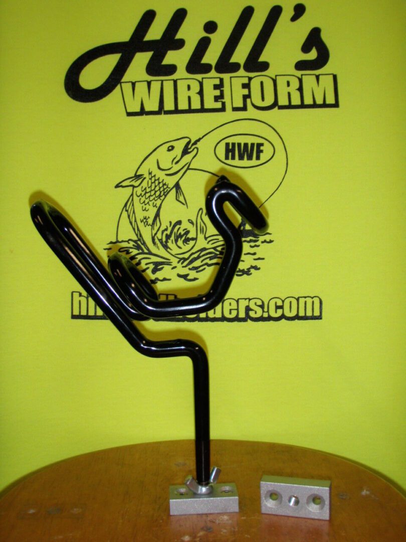 A black wire sculpture on top of a yellow table.