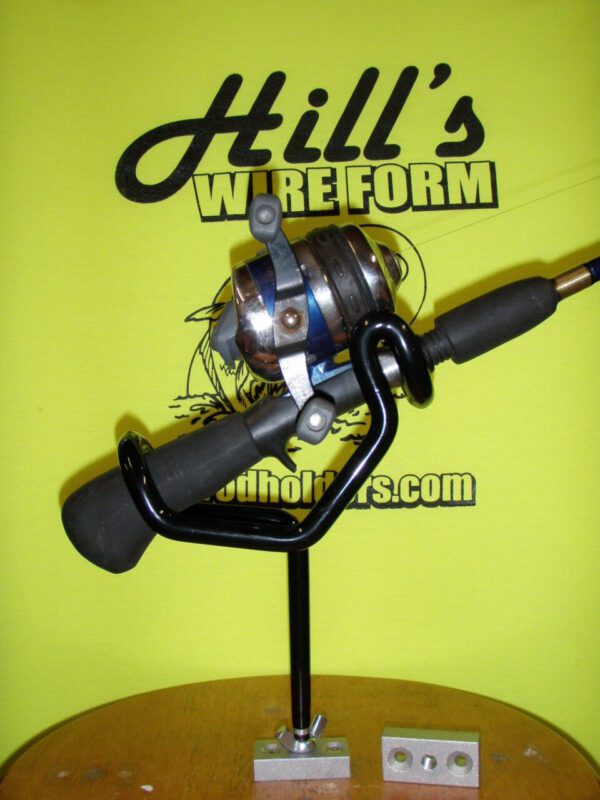 A fishing rod and reel on display in front of an advertising sign.