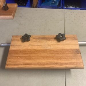 A wooden board with metal handles on top of it.