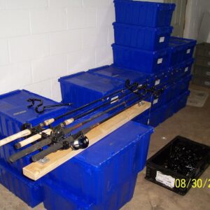 A bunch of blue boxes with some fishing rods on top