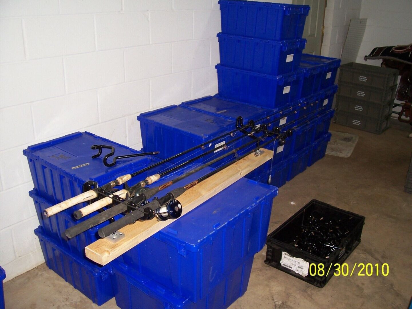 A bunch of blue boxes with some fishing rods on top