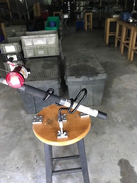 A wooden stool with a light and a red lamp on it.