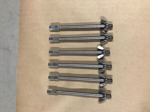 A group of eight wrenches sitting on top of a table.