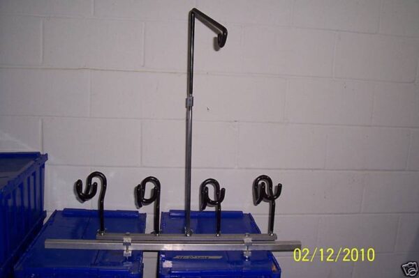 A rack with five blue plastic containers and one metal pole.