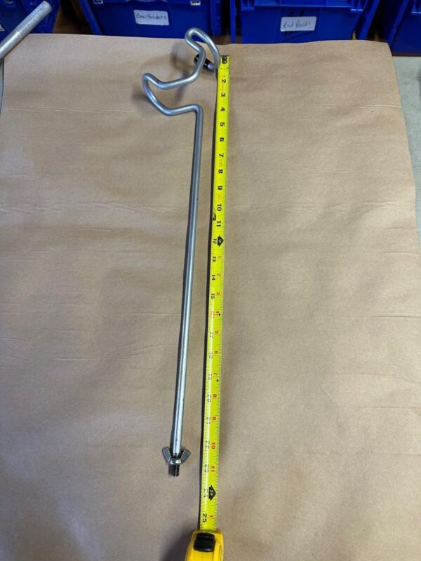 A yellow measuring tape and a metal pole