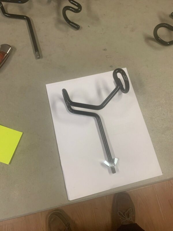 A metal object sitting on top of paper.