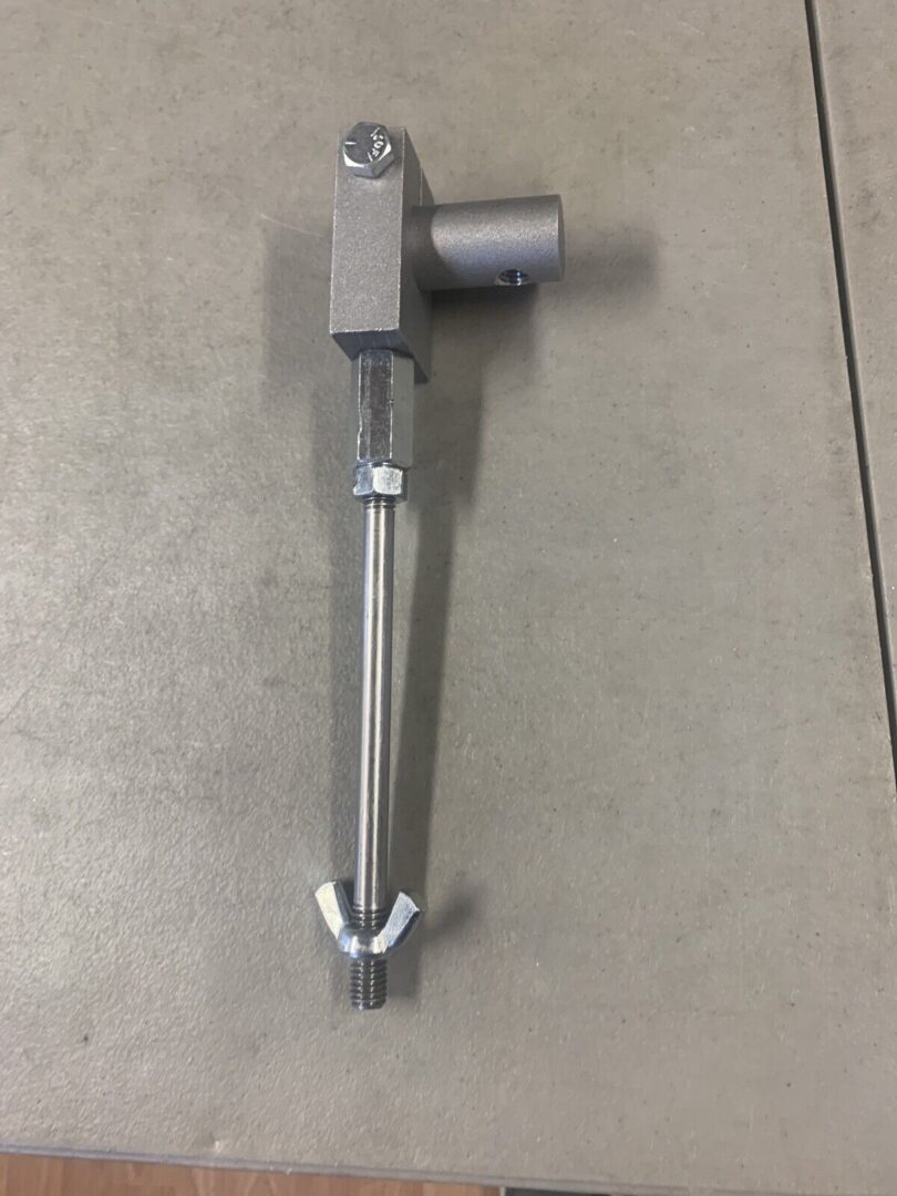 A metal pole with a nut and bolt attached to it.