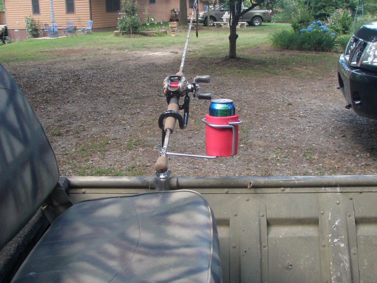 A fishing rod holder attached to the back of a truck.