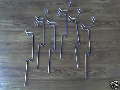 A group of metal sticks on top of a wooden floor.