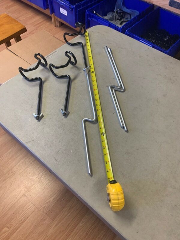 A yellow measuring tape and some metal parts