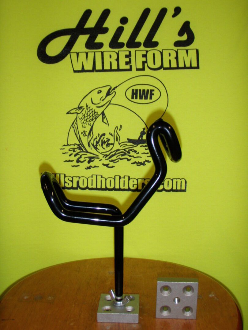 A black wire holder sitting on top of a yellow table.