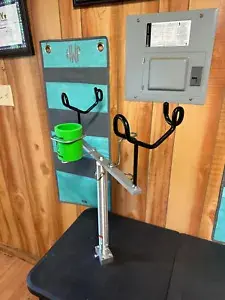 A metal pole holding cups and a cup holder.